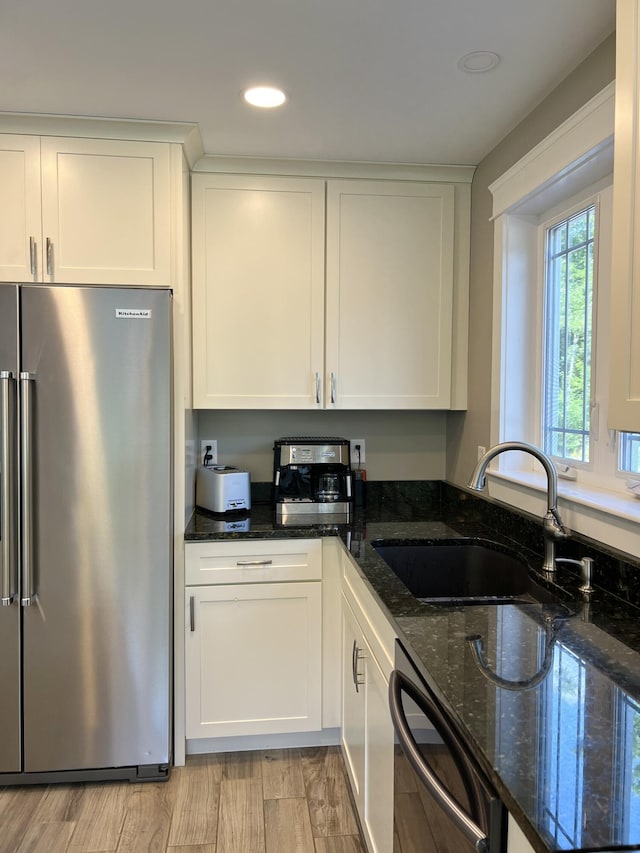 1341 Cape Rd, Limington, ME 04049 - kitchen featuring white cabinets, dishwashing machine, a sink, high end refrigerator, and dark stone counters