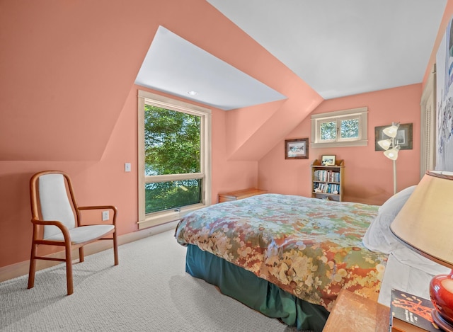 carpeted bedroom featuring lofted ceiling