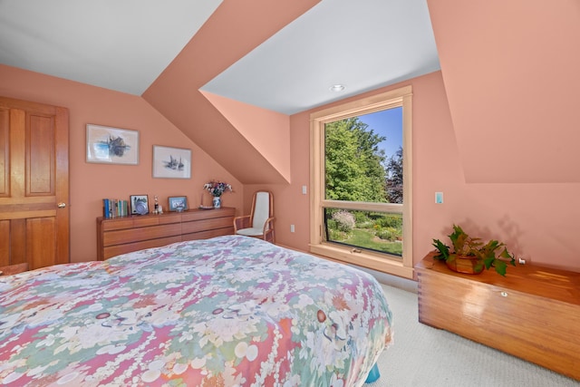 carpeted bedroom with vaulted ceiling and multiple windows