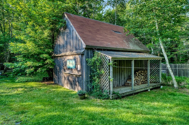 view of outbuilding featuring a lawn