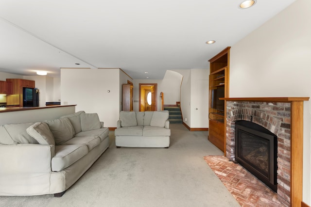 carpeted living room with a brick fireplace