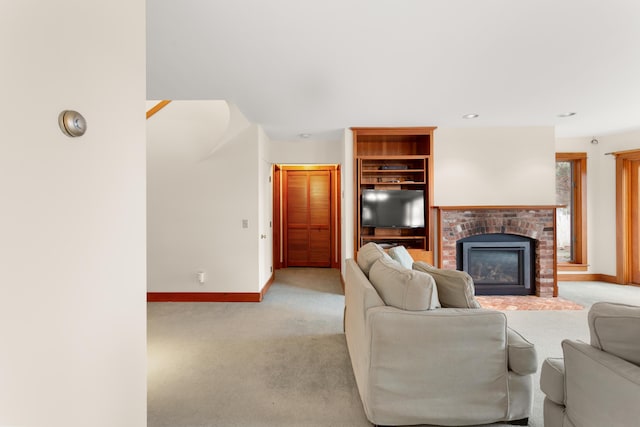 carpeted living room featuring built in features and a fireplace