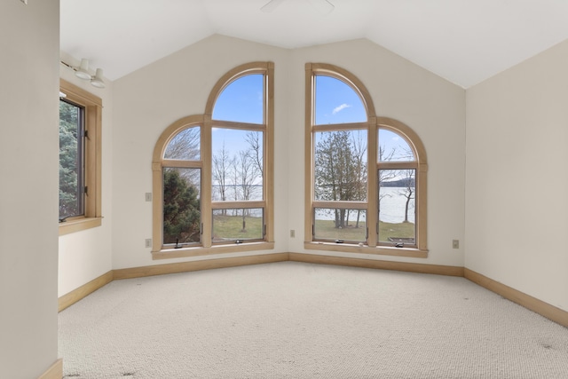 carpeted empty room featuring ceiling fan and lofted ceiling