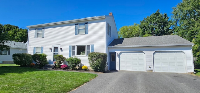 colonial home featuring a garage and a front yard