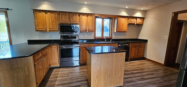 kitchen with a healthy amount of sunlight, sink, stainless steel appliances, and dark hardwood / wood-style floors