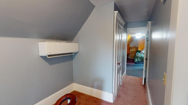 hallway featuring lofted ceiling, carpet floors, and an AC wall unit