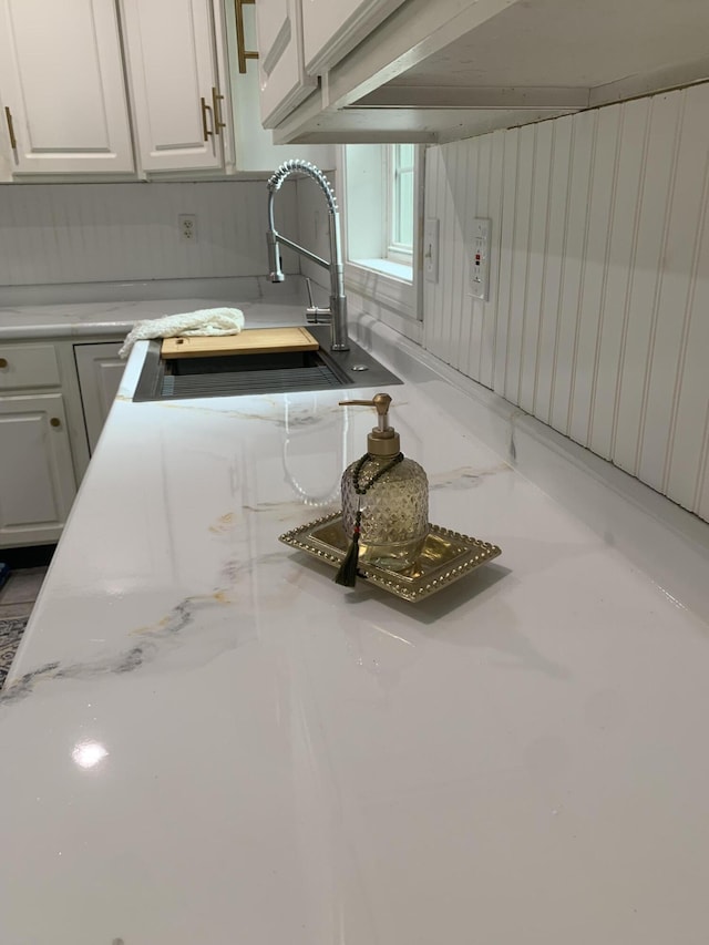 kitchen featuring sink and white cabinetry