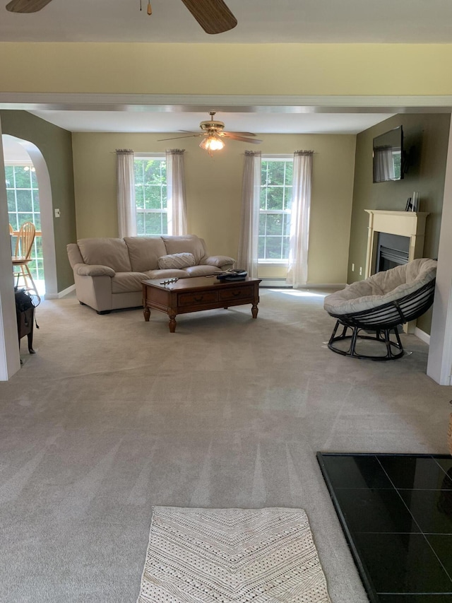 carpeted living room with ceiling fan