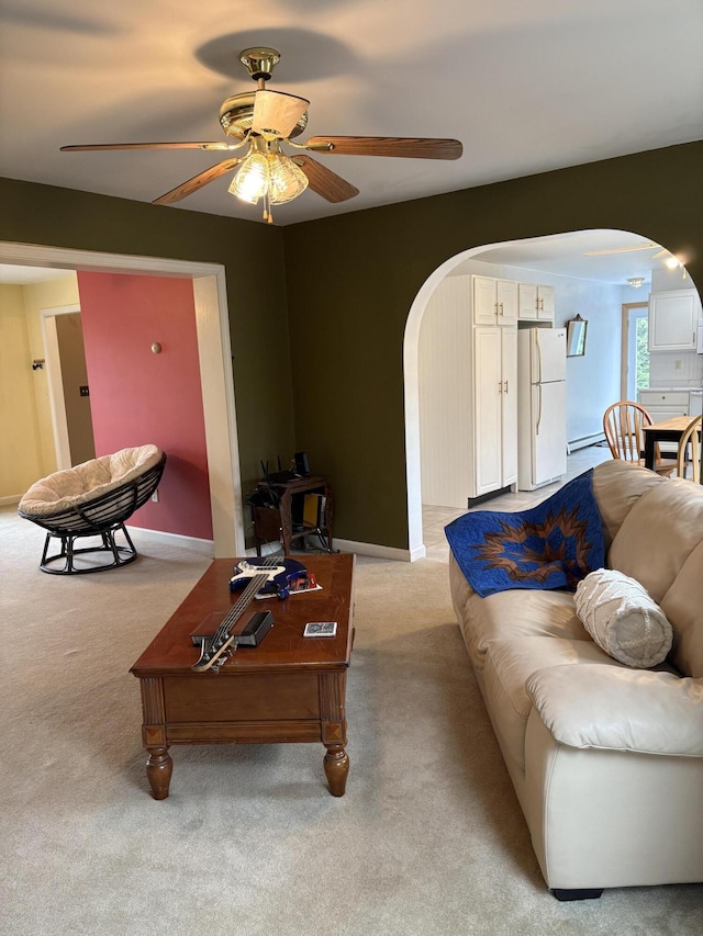 186 Line Rd, Buxton, ME 04093 - living area with arched walkways, ceiling fan, light carpet, a baseboard radiator, and baseboards
