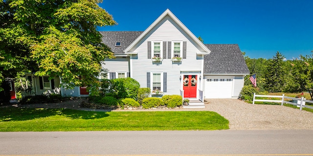 view of front of home with a garage and a front yard