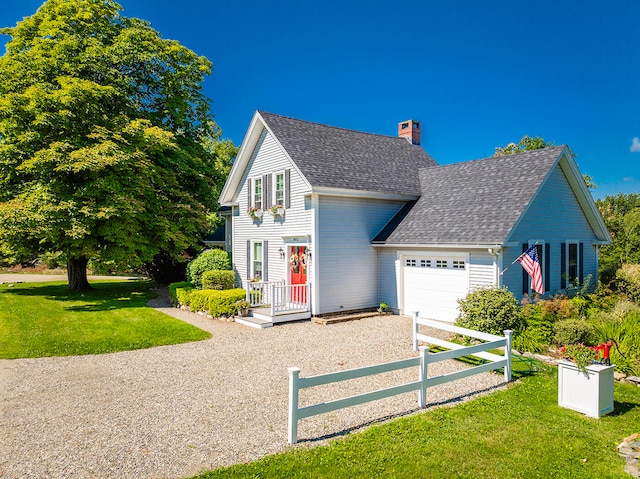 view of front of house with a garage and a front lawn