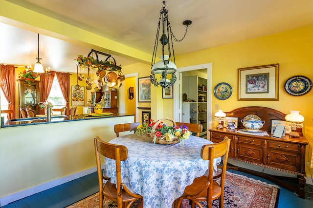 dining room with sink, hardwood / wood-style flooring, and an inviting chandelier