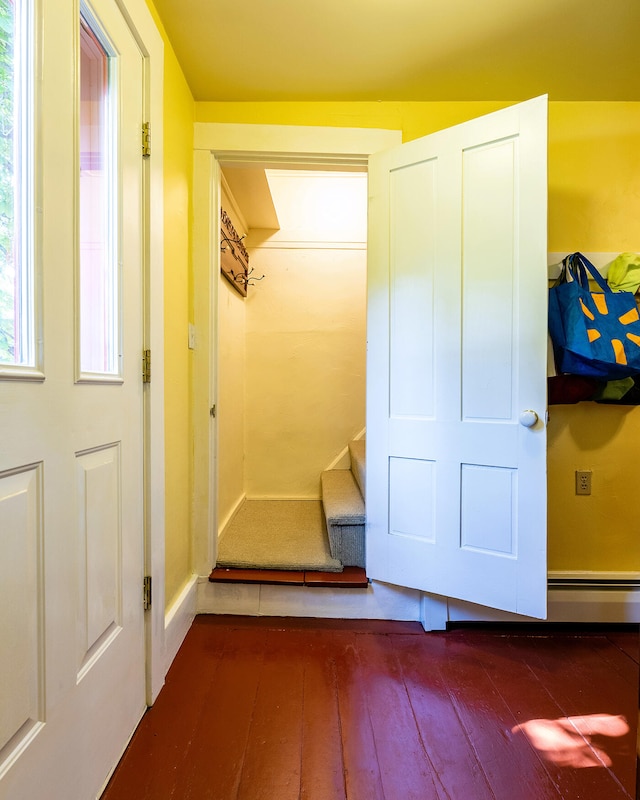 hall with wood-type flooring and a baseboard radiator