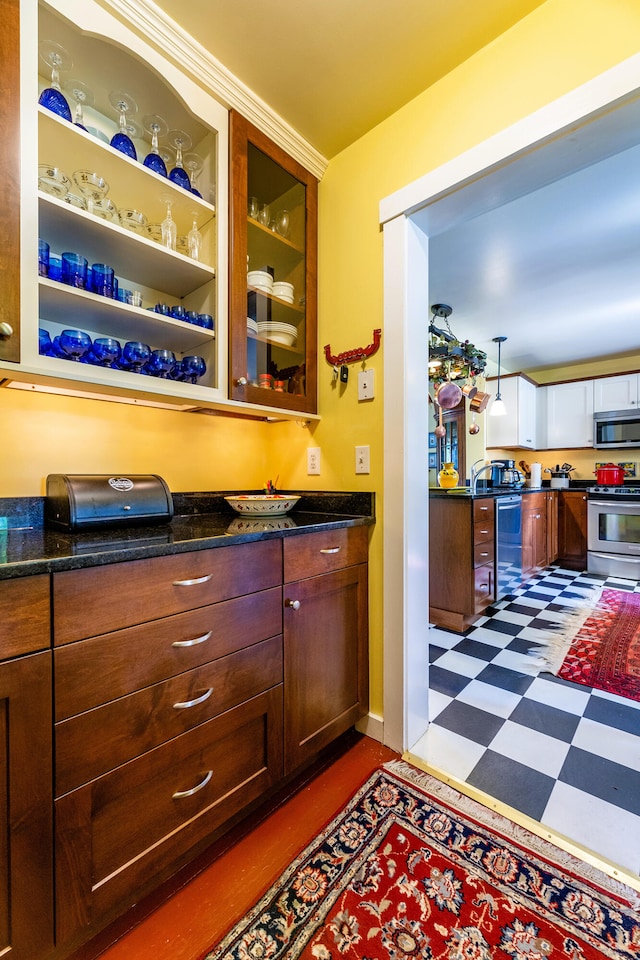 bar with wine cooler, stainless steel appliances, dark tile patterned flooring, and dark stone counters