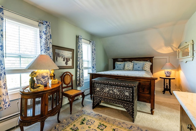 carpeted bedroom featuring a baseboard heating unit and lofted ceiling