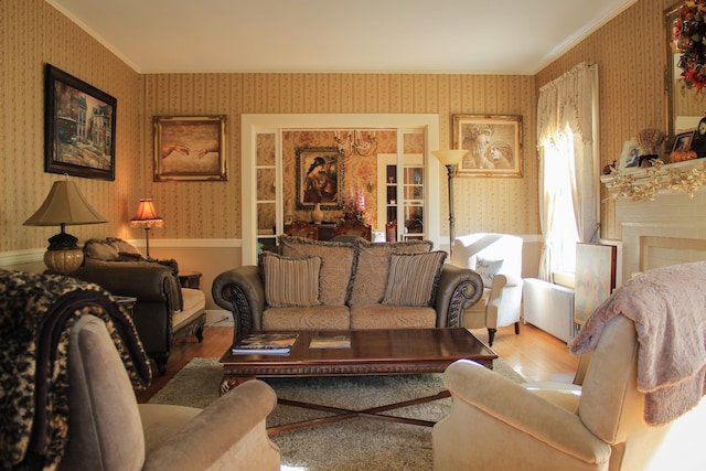 living room with hardwood / wood-style flooring and crown molding