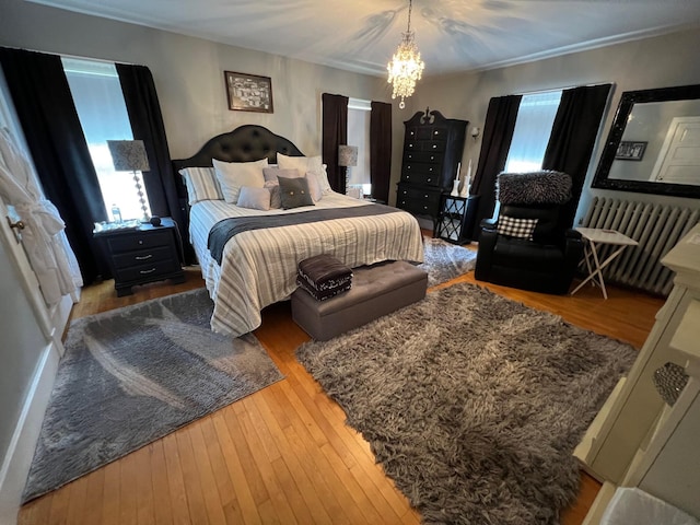 bedroom featuring hardwood / wood-style floors and a notable chandelier