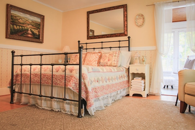 bedroom featuring ornamental molding and wood-type flooring