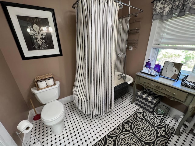 bathroom with tile patterned flooring and toilet