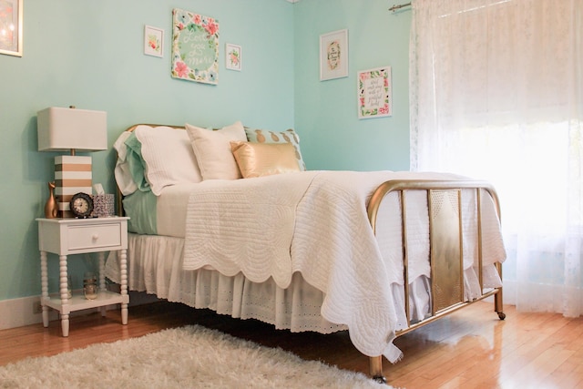 bedroom featuring wood-type flooring and multiple windows