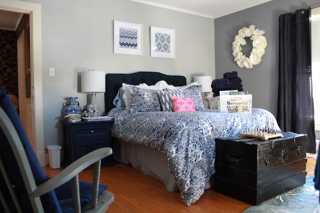 bedroom with wood-type flooring and crown molding