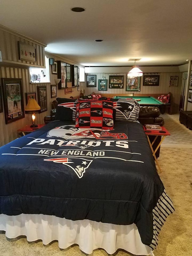 carpeted bedroom featuring billiards and wood walls