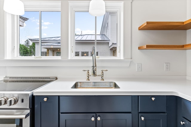 kitchen with blue cabinets, sink, and plenty of natural light