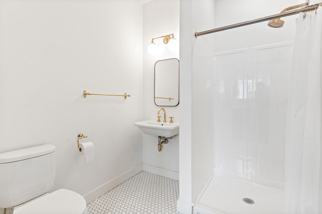 bathroom with sink, a shower, and toilet