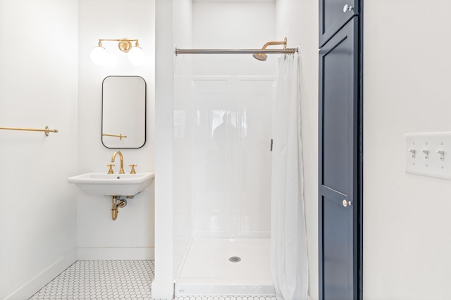 bathroom featuring sink and curtained shower