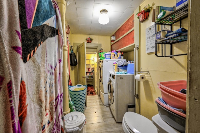 clothes washing area featuring independent washer and dryer and light wood-type flooring