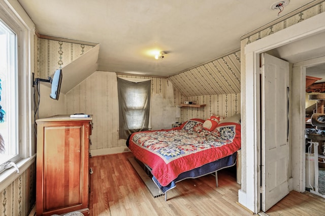 bedroom featuring hardwood / wood-style flooring and vaulted ceiling