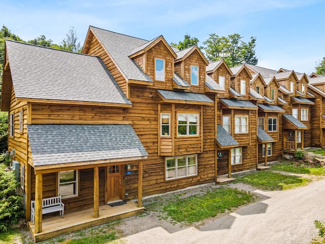 log-style house featuring a porch