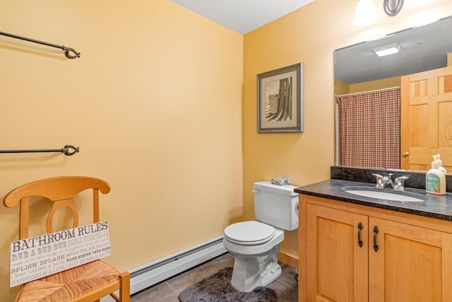 bathroom featuring tile patterned flooring, vanity, toilet, and a baseboard heating unit