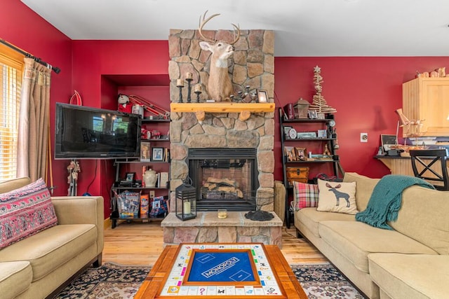 living room featuring a fireplace, hardwood / wood-style flooring, and a wealth of natural light