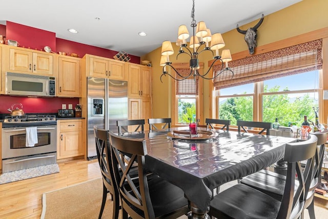 dining space featuring a chandelier and light wood-type flooring