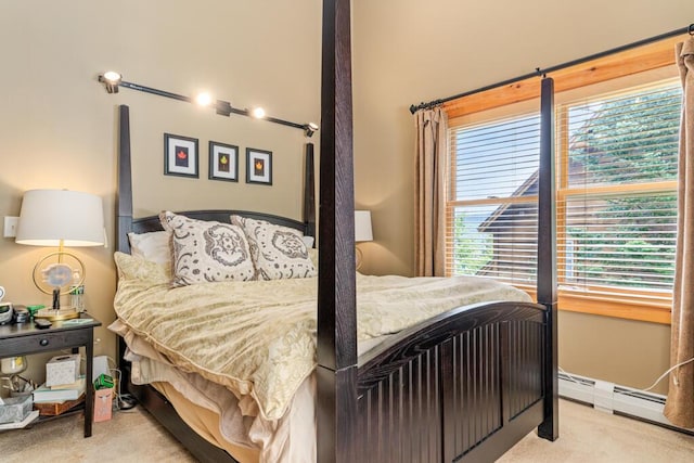 carpeted bedroom with a baseboard radiator