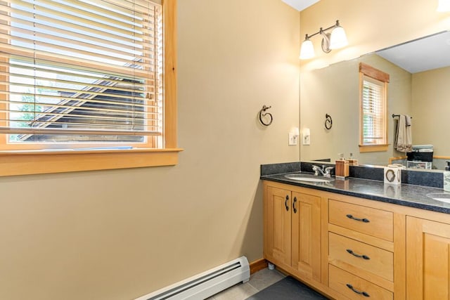 bathroom with vanity and a baseboard heating unit