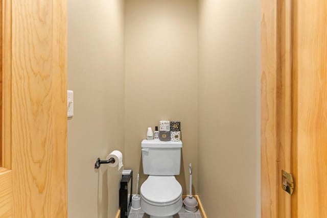 bathroom featuring tile patterned flooring and toilet