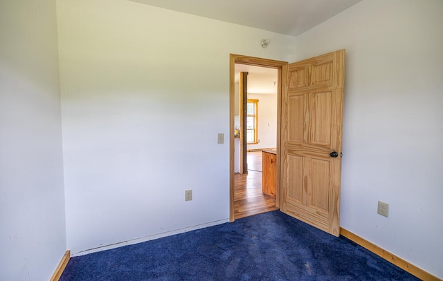 empty room with dark wood-type flooring