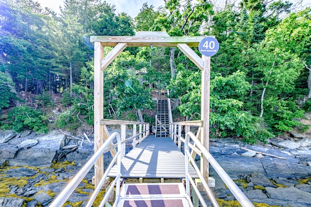 view of dock featuring a deck with water view