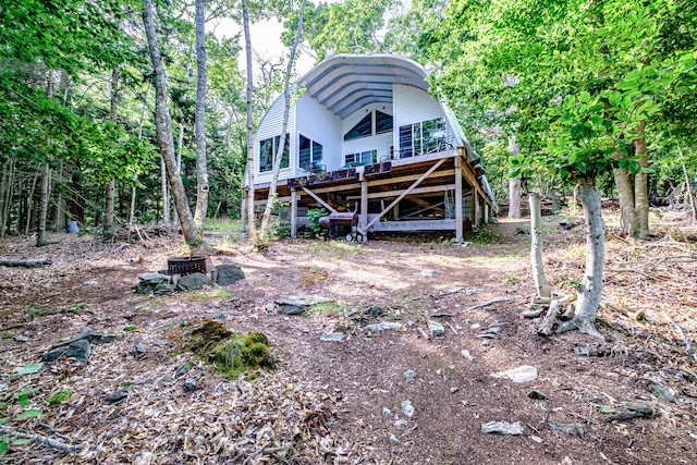 rear view of house with a wooden deck