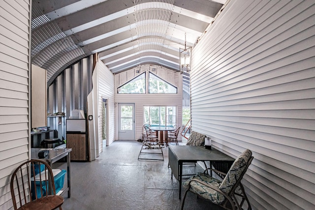 sunroom featuring vaulted ceiling