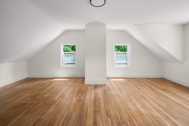 bonus room featuring lofted ceiling and light wood-type flooring