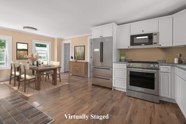 kitchen featuring crown molding, stainless steel appliances, white cabinets, and dark hardwood / wood-style floors