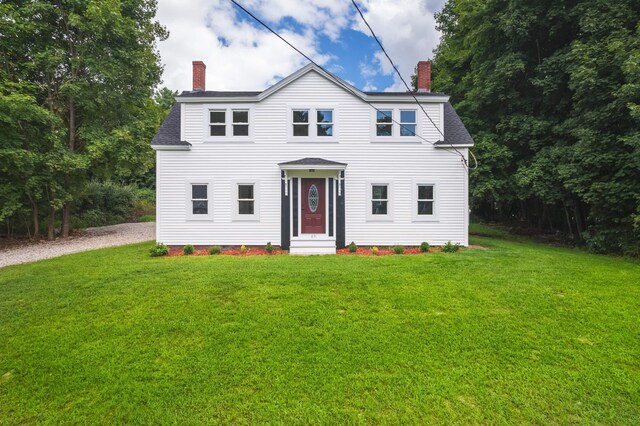 colonial-style house with a front lawn