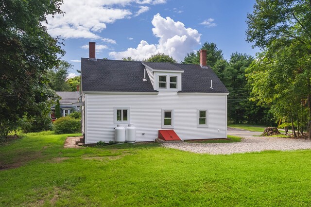 rear view of house with a yard