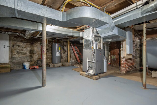 basement with electric panel, heating unit, and water heater