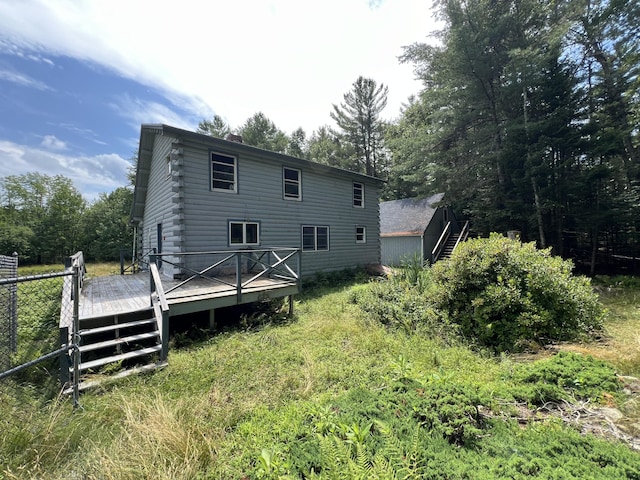 rear view of property with a wooden deck