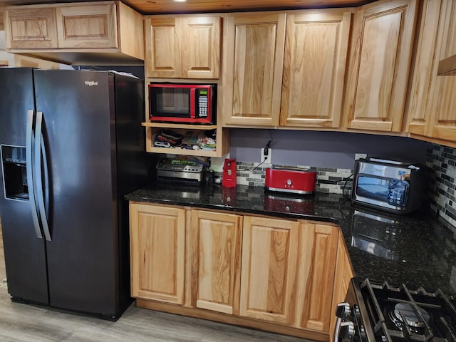 19 Resh Rd, Searsport, ME 04974 - kitchen with black fridge with ice dispenser, range with gas cooktop, light brown cabinets, and stainless steel microwave