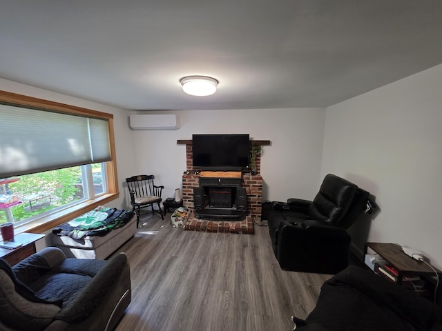 19 Resh Rd, Searsport, ME 04974 - living area with a wall mounted AC, wood finished floors, and a fireplace